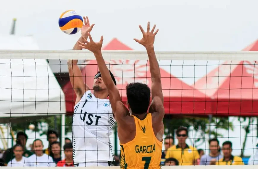 Latest Articles 57 How to Play Beach Volleyball: A male Beachvolleyball Player hitting a ball while another player wants to block