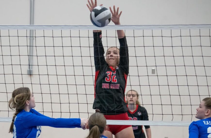 Latest Articles 19 How to Play Volleyball for Beginners: A female volleyball player blocking a ball at the net