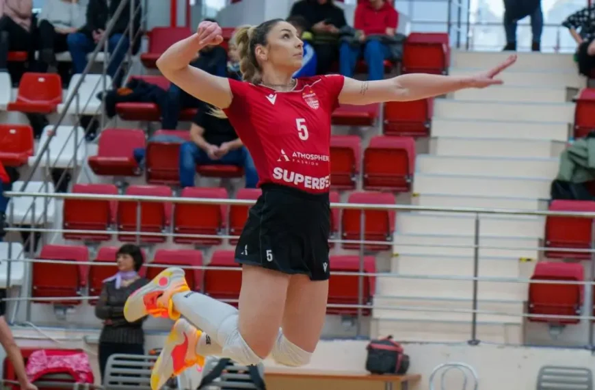 Latest Articles 73 Volleyball Outfits for Women: Women with red jersey, black shorts and white knee pads spiking a volleyball